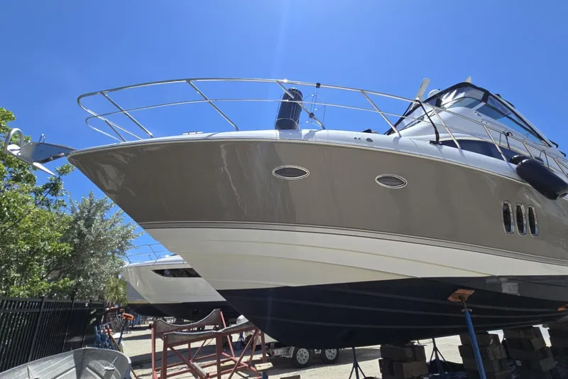 Slide: The Image of 2007 Cruisers Yachts 447 Sport Sedan on dry dock under clear blue sky. - 9
