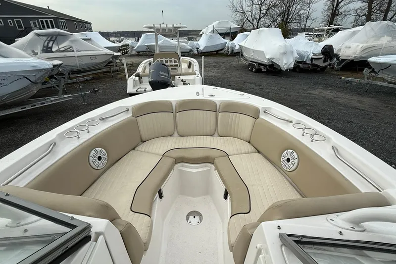 Slide: The Image of 2019 Sea Fox 226 Traveler boat with spacious seating, parked among covered boats. - 14