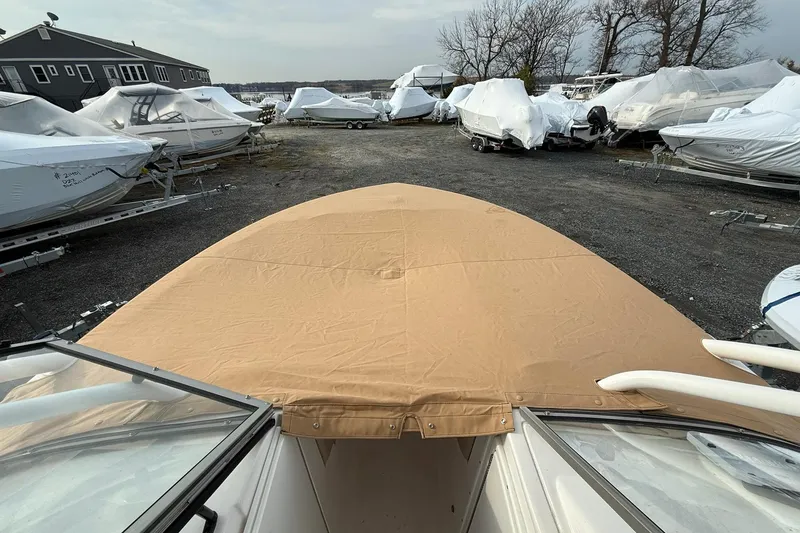 Slide: The Image of 2019 Sea Fox 226 Traveler boat with tan cover in storage yard. - 18