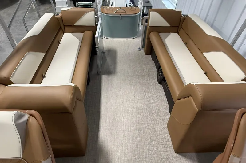 Slide: The Image of Luxurious interior of 2026 Avalon Venture Quad Lounge boat with tan and cream seating. - 15