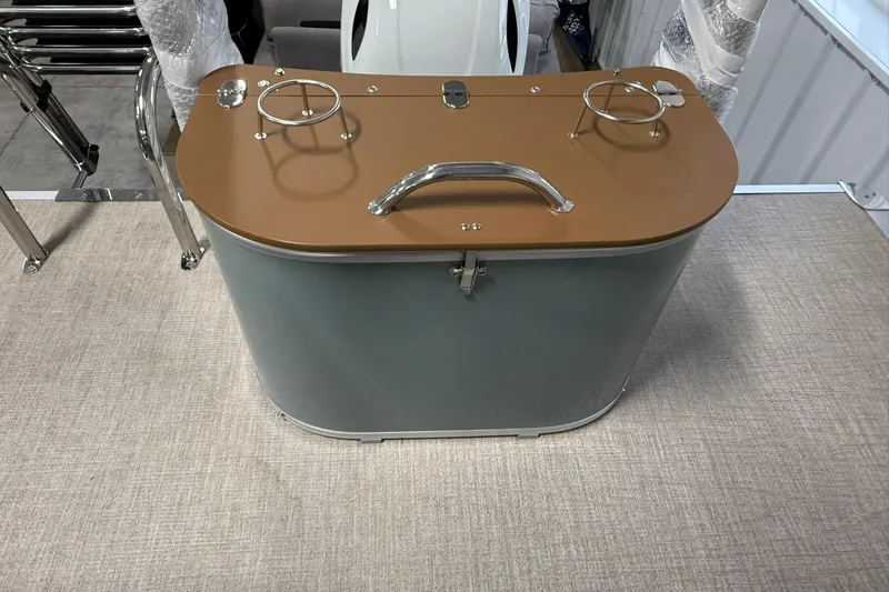 Slide: The Image of 2026 Avalon Venture Quad Lounge boat interior with a compact bar and cup holders. - 16