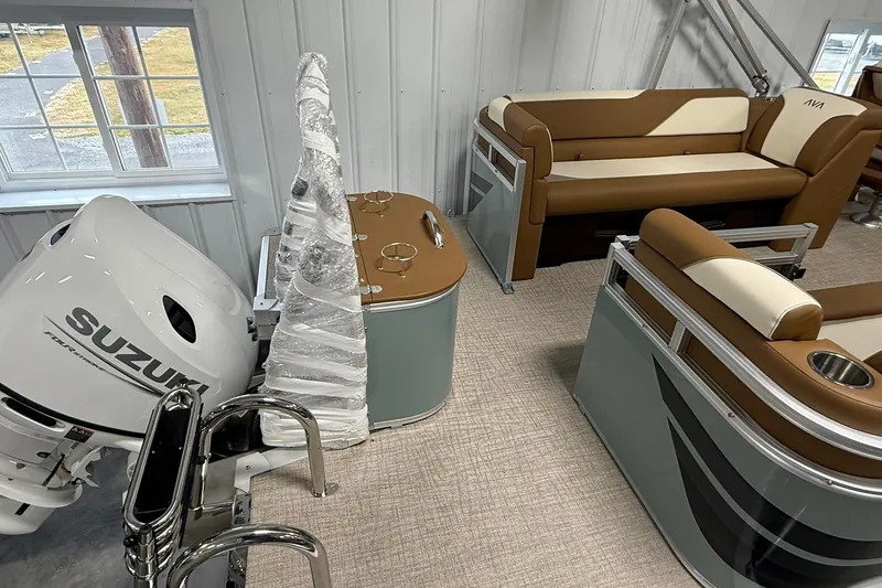 Slide: The Image of 2026 Avalon Venture Quad Lounge boat interior with Suzuki engine, featuring brown and cream seating. - 6