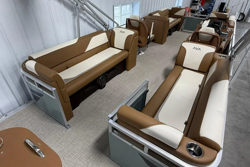 Slide: The Image of 2026 Avalon Venture Quad Lounge interior with brown and cream seating, spacious layout. - 7