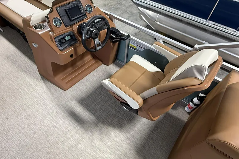 Slide: The Image of 2026 Avalon Venture Quad Lounge boat interior with captain's chair and control panel. - 9