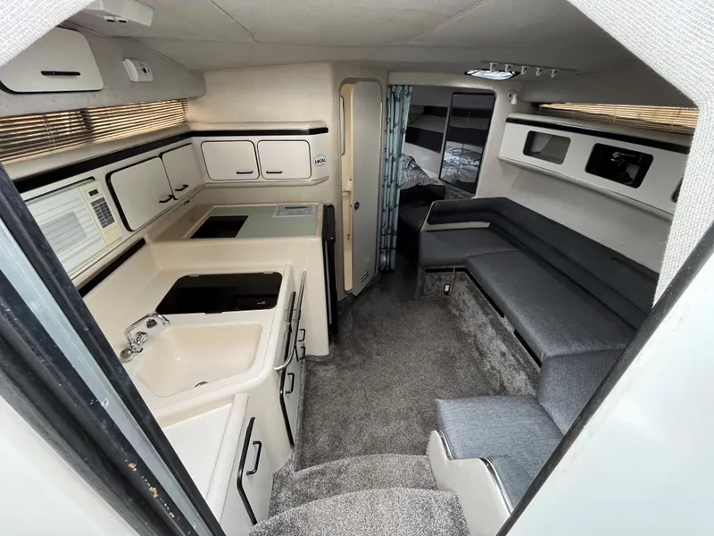 Slide: The Image of Interior of a 1993 Sea Ray 330 Express yacht with kitchen and seating area. - 12