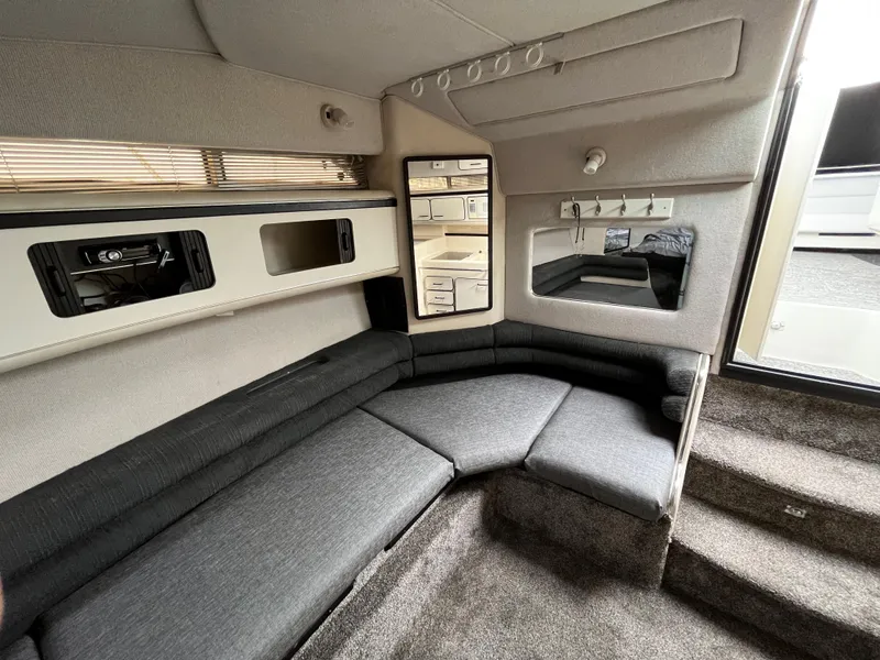 Slide: The Image of Interior of a 1993 Sea Ray 330 Express with gray sofa. - 14