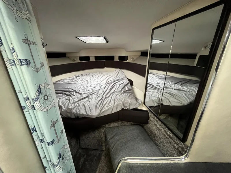 Slide: The Image of 1993 Sea Ray 330 Express interior with bed and mirror. - 17