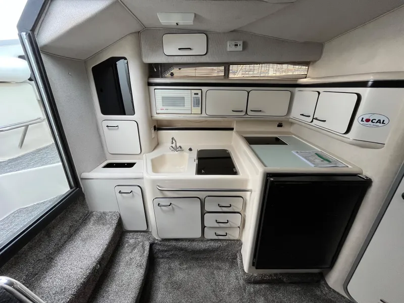 Slide: The Image of Interior of 1993 Sea Ray 330 Express with kitchen and appliances. - 19