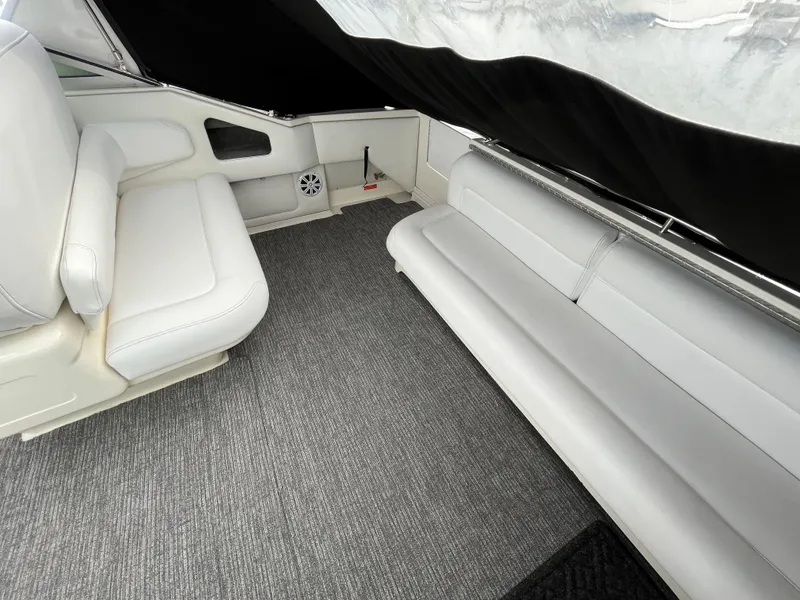 Slide: The Image of Interior of a 1993 Sea Ray 330 Express with gray carpet and white seating. - 8