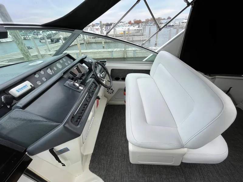 Slide: The Image of Interior of a 1993 Sea Ray 330 Express with helm and seating. - 9