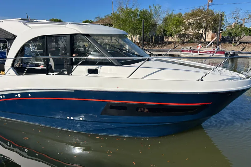 The Image of 2022 Beneteau Antares 9 boat docked on calm water, showcasing sleek design. - 0