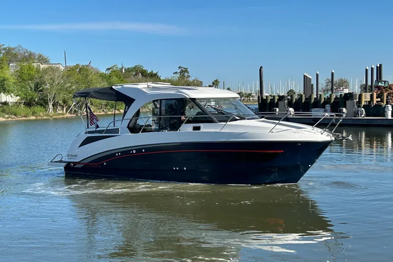 Slide: The Image of 2022 Beneteau Antares 9 boat cruising on a calm river. - 24