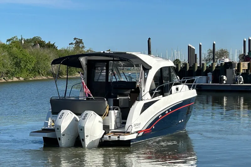 Slide: The Image of 2022 Beneteau Antares 9 boat with twin engines on a calm waterway. - 25