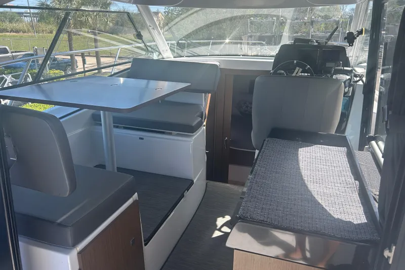 Slide: The Image of Interior of 2022 Beneteau Antares 9 boat with seating and table arrangement. - 31