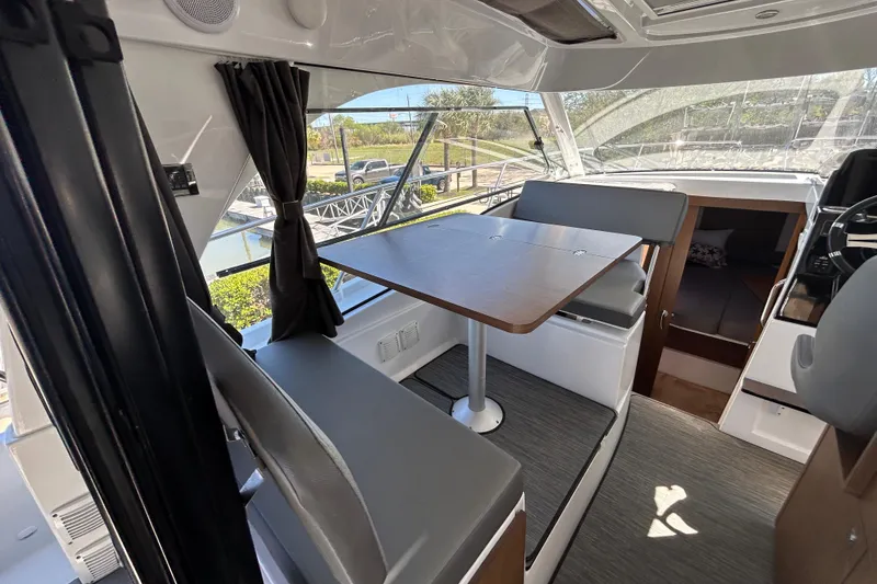 Slide: The Image of Interior of 2022 Beneteau Antares 9 boat with dining area and seating. - 34