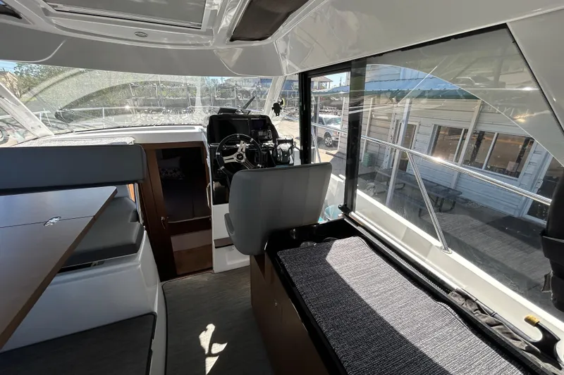Slide: The Image of Interior of 2022 Beneteau Antares 9 boat, featuring helm and seating area. - 35