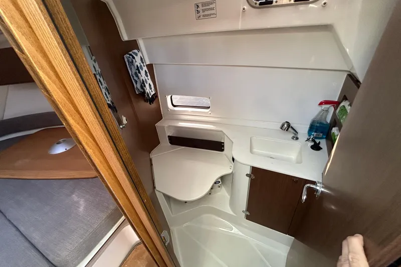 Slide: The Image of Interior of 2022 Beneteau Antares 9 boat bathroom with sink and storage. - 38