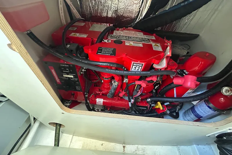 Slide: The Image of Engine compartment of 2022 Beneteau Antares 9 with red EFI engine and fire extinguisher. - 46