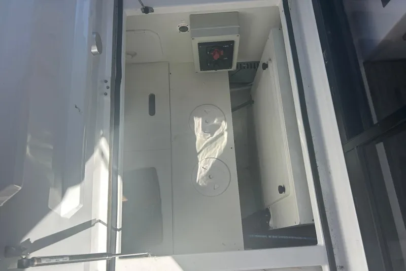 Slide: The Image of Interior view of 2022 Beneteau Antares 9 boat compartment with storage and control panel. - 47