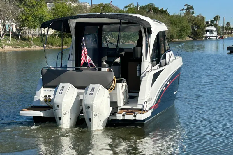 Slide: The Image of 2022 Beneteau Antares 9 boat with dual engines on a calm waterway. - 5