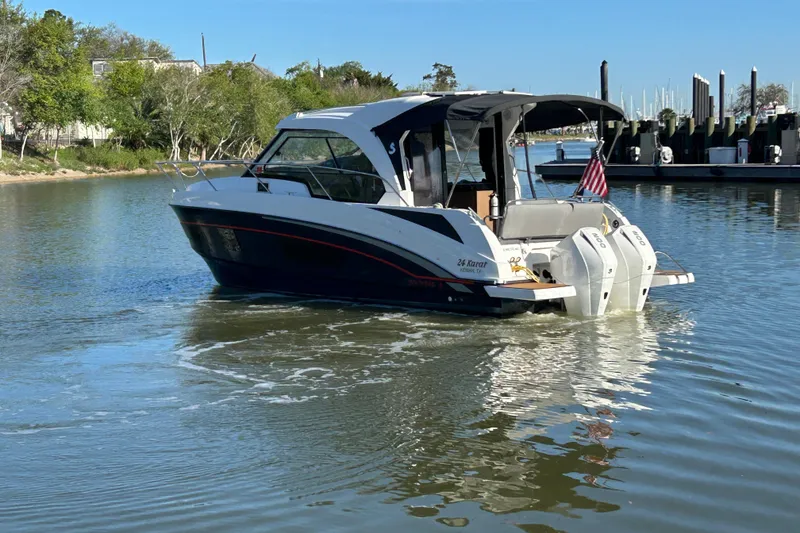 Slide: The Image of 2022 Beneteau Antares 9 cruising on a calm river near a marina. - 7