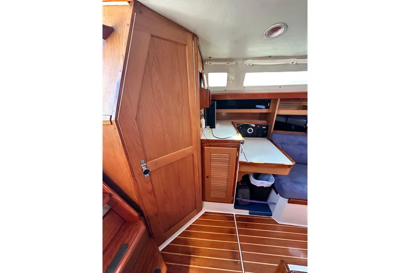 Slide: The Image of Interior of 1994 Catalina 34 MkII sailboat with wooden cabinetry and navigation station. - 11