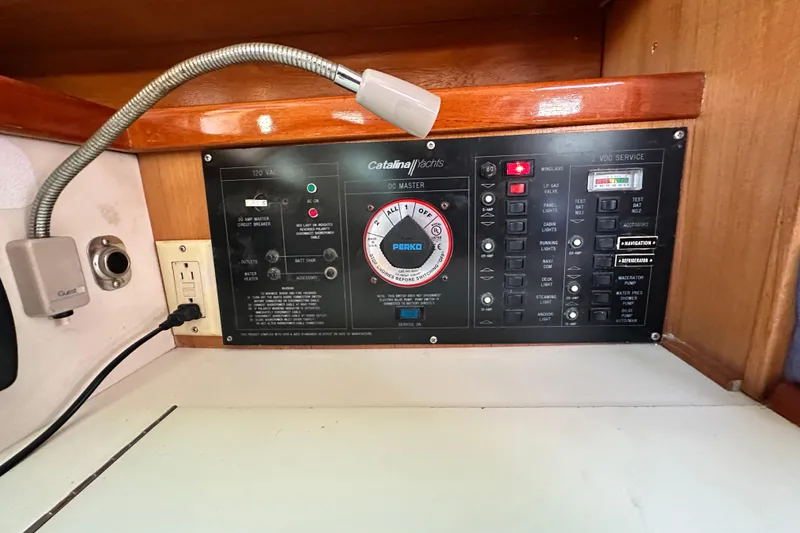 Slide: The Image of Electrical control panel of a 1994 Catalina 34 MkII yacht with various switches and gauges. - 13