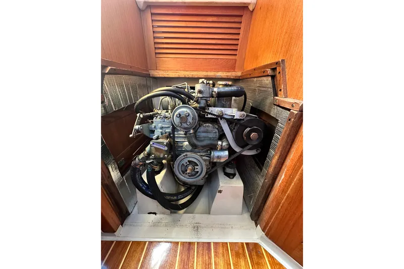 Slide: The Image of Engine compartment of a 1994 Catalina 34 MkII sailboat, showcasing mechanical components. - 15