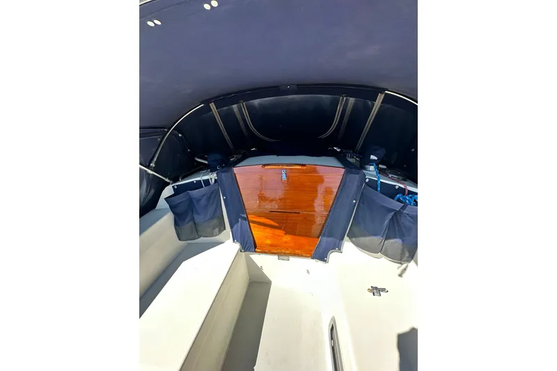Slide: The Image of 1994 Catalina 34 MkII sailboat cockpit with wooden hatch and navy blue canopy. - 16