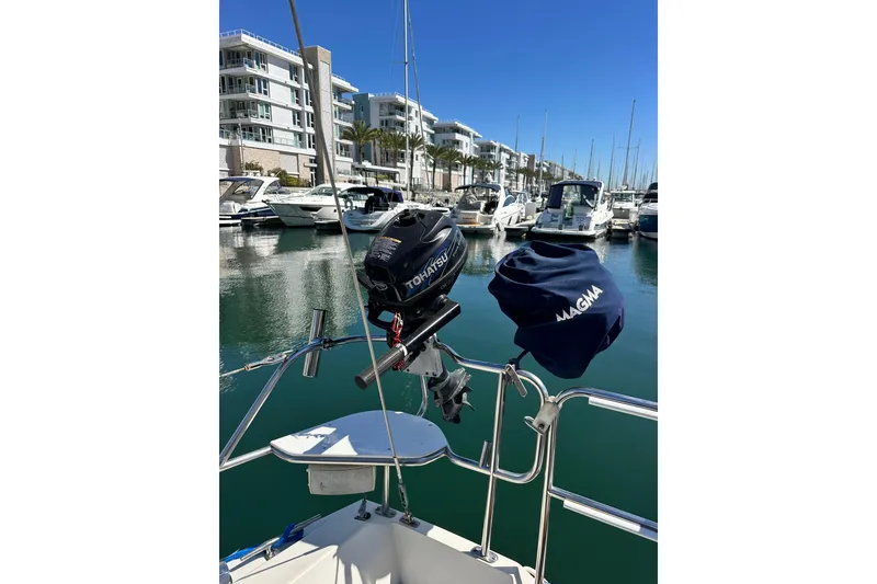 Slide: The Image of Catalina 34 MkII sailboat in marina, featuring Tohatsu outboard motor and Magma grill. - 17