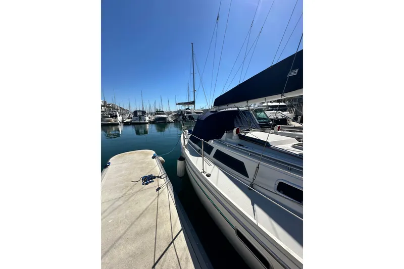 Slide: The Image of 1994 Catalina 34 MkII sailboat docked in a marina under clear blue skies. - 18