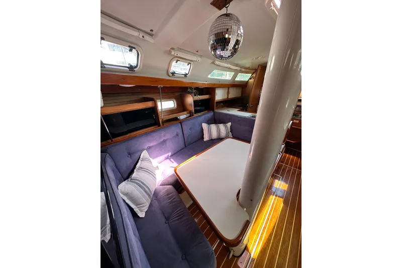 Slide: The Image of Interior of 1994 Catalina 34 MkII sailboat with cozy seating and disco ball. - 5