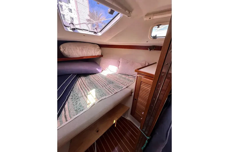 Slide: The Image of Cozy cabin interior of 1994 Catalina 34 MkII sailboat with bedding and wooden cabinetry. - 7
