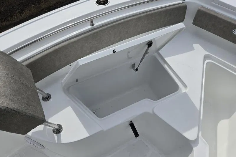 Slide: The Image of 2025 Sea Hunt Ultra 229 boat interior with open storage compartment and seating. - 11