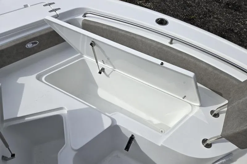 Slide: The Image of 2025 Sea Hunt Ultra 229 boat storage compartment with open lid, showcasing spacious interior. - 12