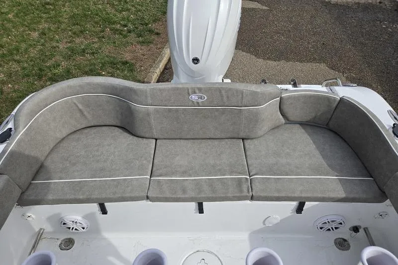 Slide: The Image of 2025 Sea Hunt Ultra 229 boat with cushioned seating and modern design. - 15