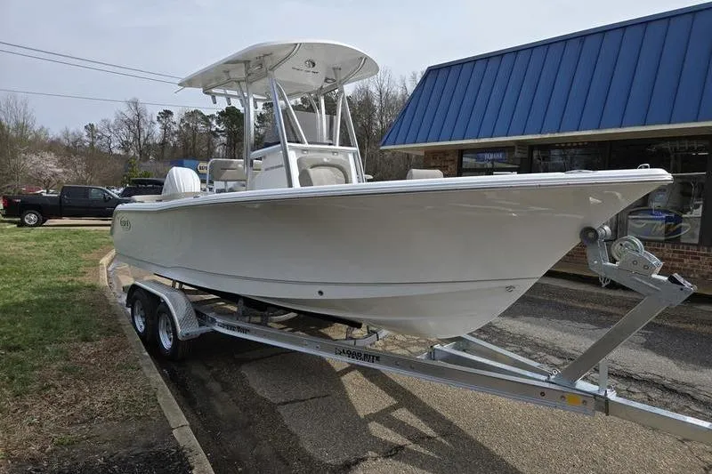 Slide: The Image of 2025 Sea Hunt Ultra 229 boat on trailer outside a building. - 3