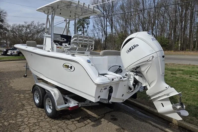Slide: The Image of 2025 Sea Hunt Ultra 229 boat with Yamaha engine on trailer, parked outdoors. - 4