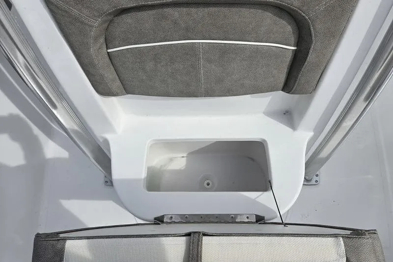 Slide: The Image of 2025 Sea Hunt Ultra 229 boat interior with cushioned seating and storage compartment. - 7