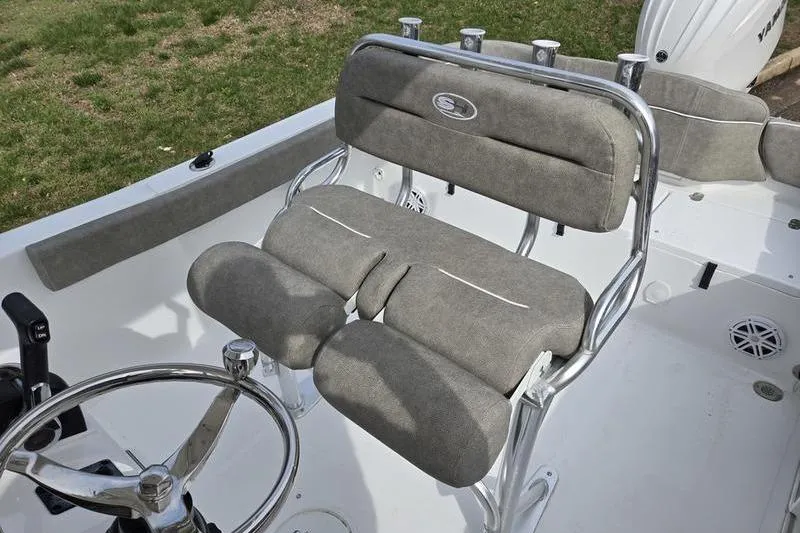 Slide: The Image of 2025 Sea Hunt Ultra 229 boat interior with cushioned seating and steering wheel. - 9