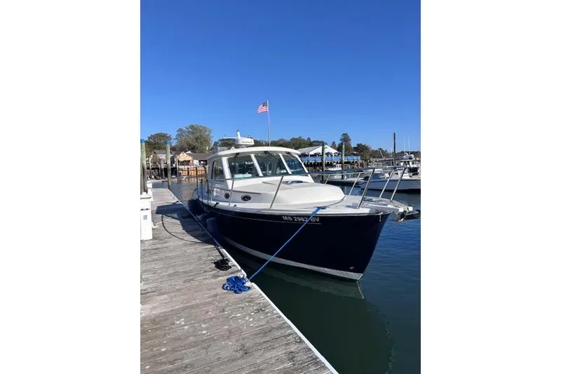 The Image of 2018 Back Cove 30 boat docked at marina under clear blue sky. - 0