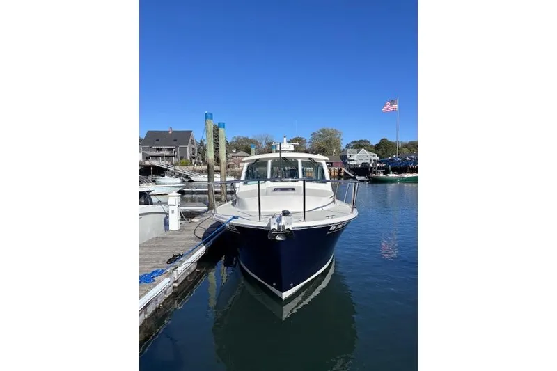 Slide: The Image of 2018 Back Cove 30 boat docked in a marina under clear blue sky. - 2