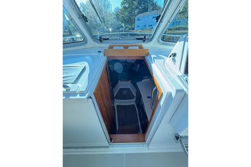 Slide: The Image of 2018 Back Cove 30 boat interior with wooden hatch and seating area. - 21