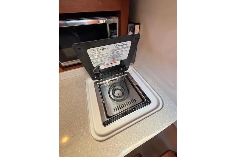 Slide: The Image of Built-in stove on 2018 Back Cove 30 yacht, with safety warnings visible. - 33