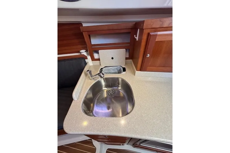 Slide: The Image of 2018 Back Cove 30 yacht interior with stainless steel sink and wooden cabinetry. - 34