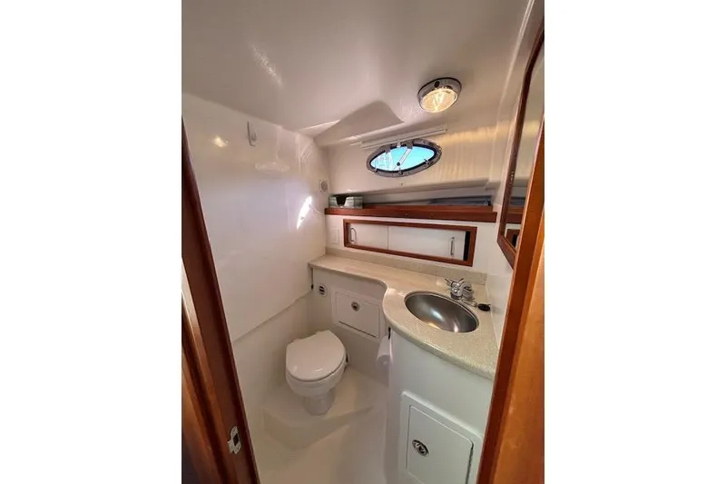 Slide: The Image of Compact bathroom in a 2018 Back Cove 30 boat, featuring a toilet, sink, and storage. - 36