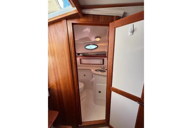 Slide: The Image of 2018 Back Cove 30 yacht interior bathroom with wooden finish and compact design. - 37