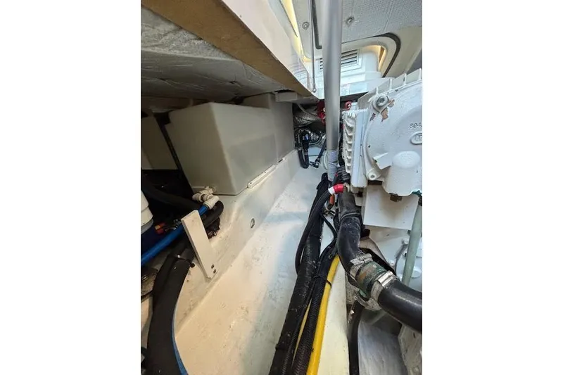 Slide: The Image of Engine compartment of a 2018 Back Cove 30 boat, showcasing mechanical components and wiring. - 43