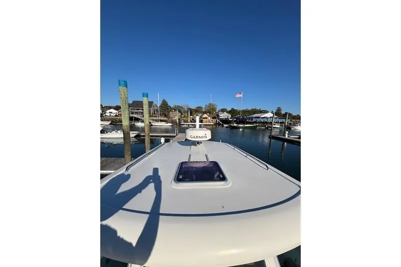 Slide: The Image of 2018 Back Cove 30 boat docked at marina under clear blue sky. - 48