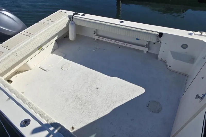 Slide: The Image of 2007 Parker 2320 SL Sport Cabin boat docked in a serene marina setting. - 2